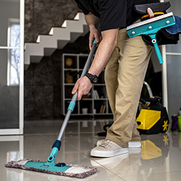 Un homme passe la serpillère avec des équipements de nettoyage professionnels